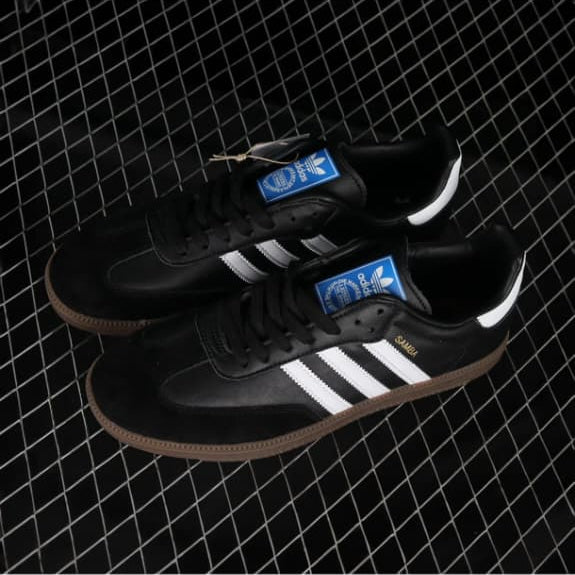 Black Adidas shoes with white stripes on a black and white checkered background