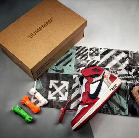 Kith x Nike sneakers with a cardboard box on a gray surface