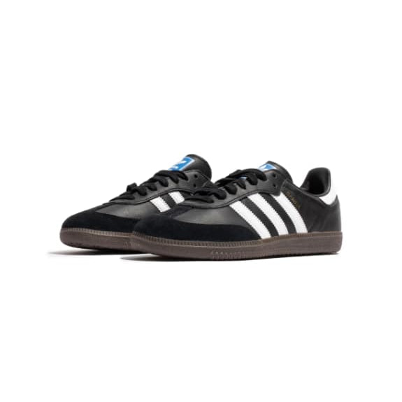 Black Adidas sneakers with white stripes on a white background