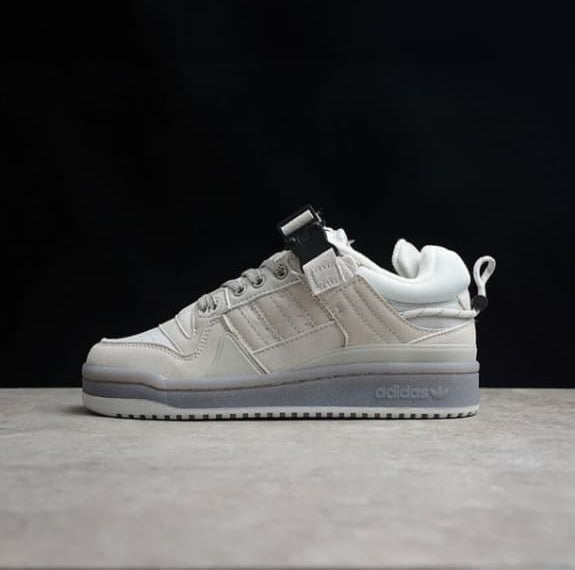 White sneaker on a dark background with a Shopify checkout page overlay.